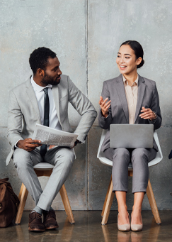 Two business people sitting and talking