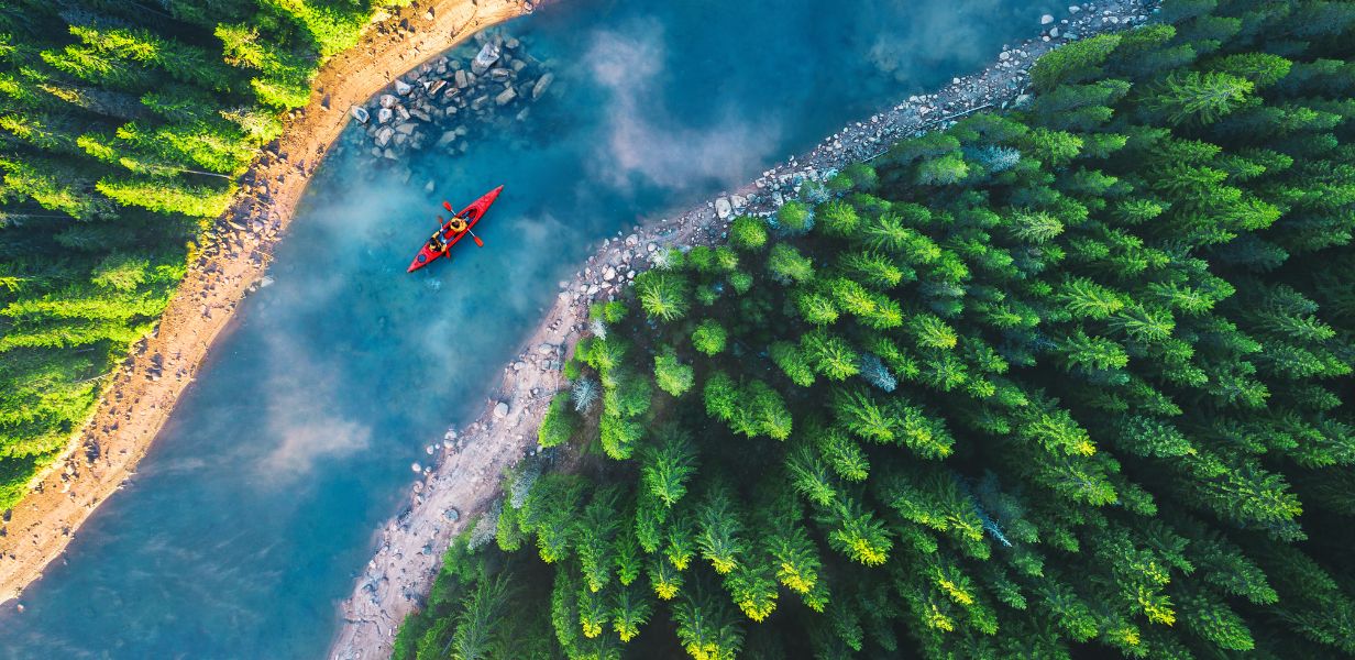 Kayak, river with rocks and trees.